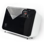 Compact enclosure with glossy black front panel, cooling fan, and white shell, shown on elevated feet.